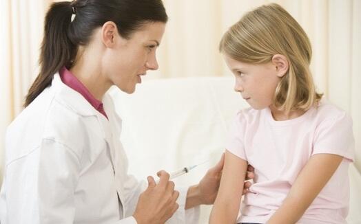 Nurse giving vaccination to a child